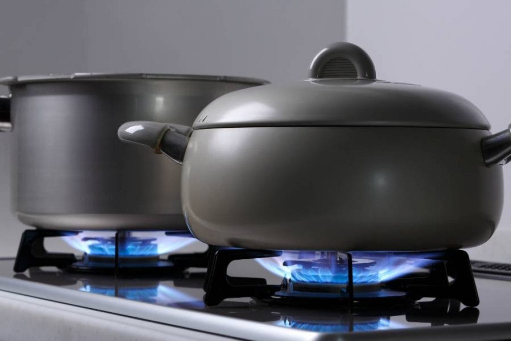 Flat induction cookware with ferromagnetic material on gas stove